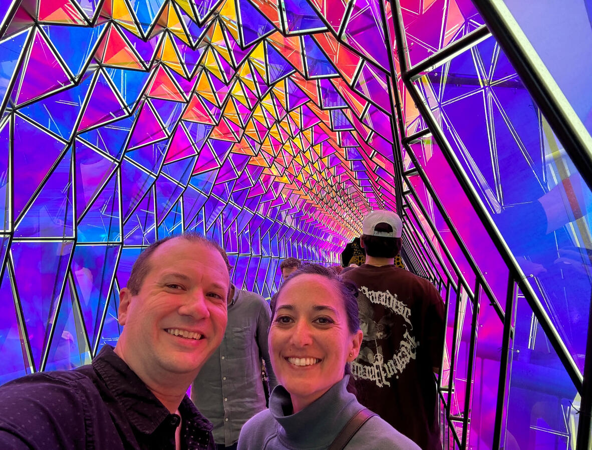 Untitled Michael and Michelle selfie within an artsy tunnel of saturated bright colorful geometric glass.